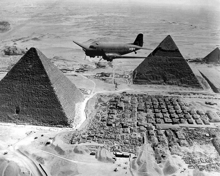 Airplane flying over the Pyramids of Giza, Egypt