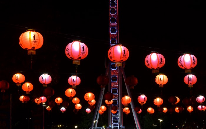 Red lanterns and Ferris wheel at night