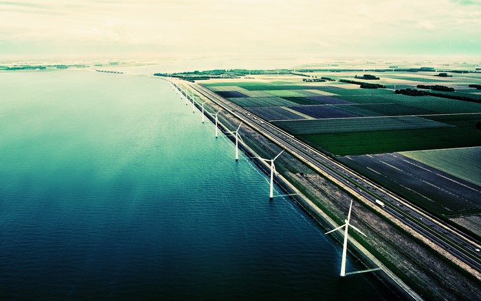 Wind turbines along a causeway with farmland
