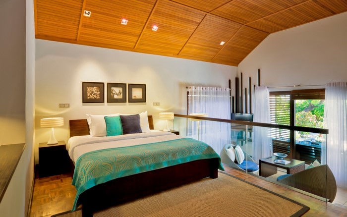 Bedroom with wooden ceiling and balcony