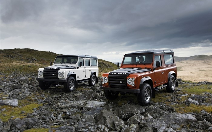 Two Land Rover Defenders on rocky terrain