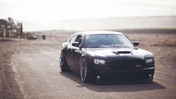 Black Dodge Charger SRT8 on a dirt road