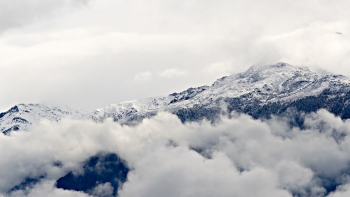 Snow-covered mountains shrouded in clouds