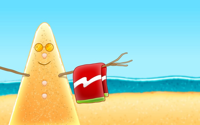 Sand snowman with sunglasses and towel on beach