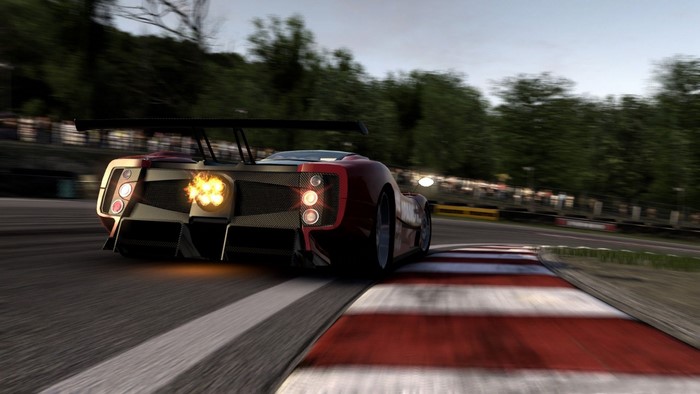 Red race car with flames from exhaust on track