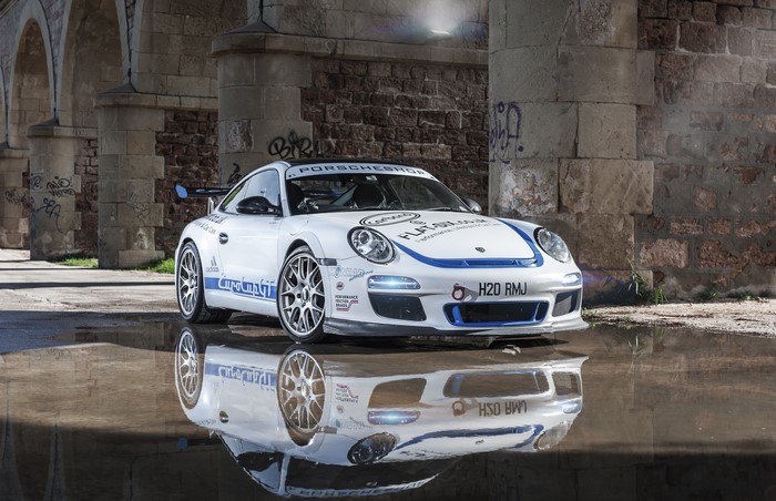 White Porsche race car with blue stripes