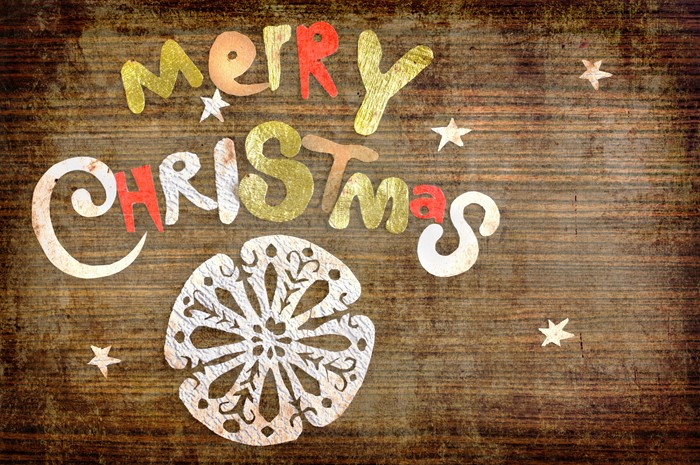 Merry Christmas text and snowflake on wood