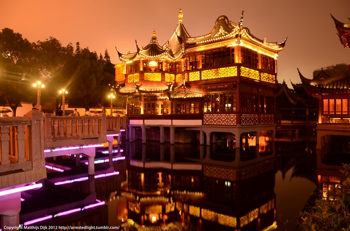 Oriental building on water at dusk
