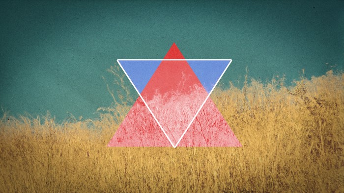 Geometric shapes over dry grass and teal sky