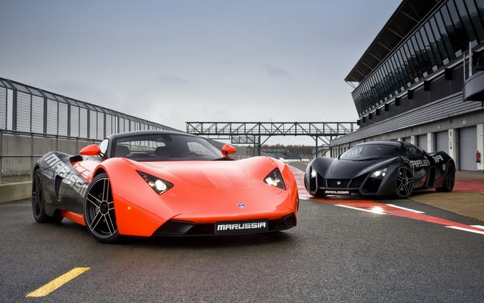 Two Marussia sports cars on a race track