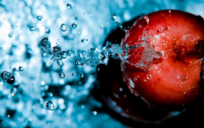 Red apple with water splashes