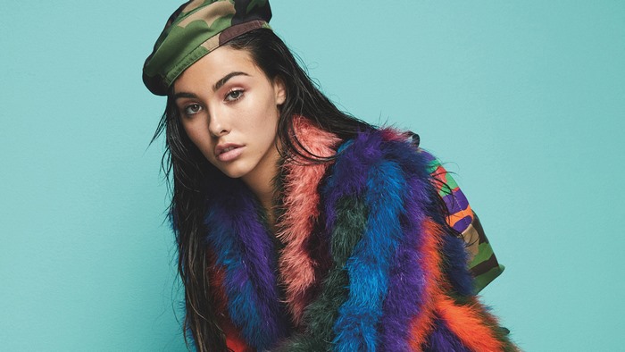 Madison Beer wearing a camouflage beret and colorful fur coat
