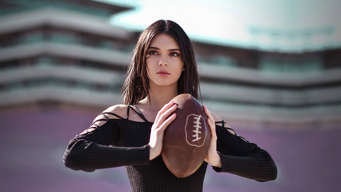 Kendall Jenner holding a football