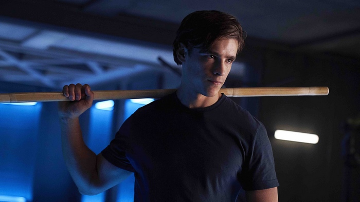 Dick Grayson from Titans holding a wooden staff
