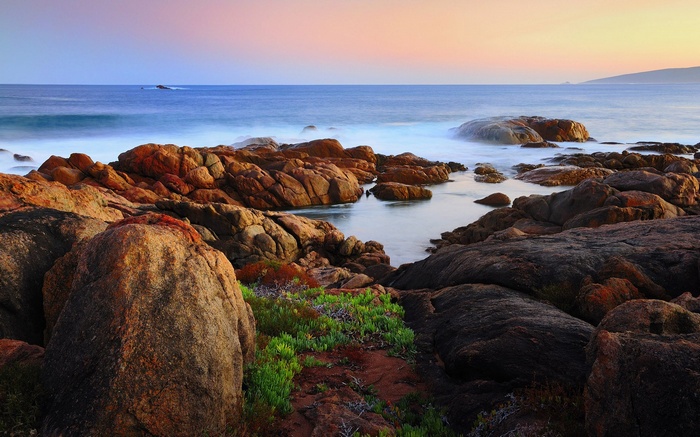 Rocky coastline with ocean at sunset