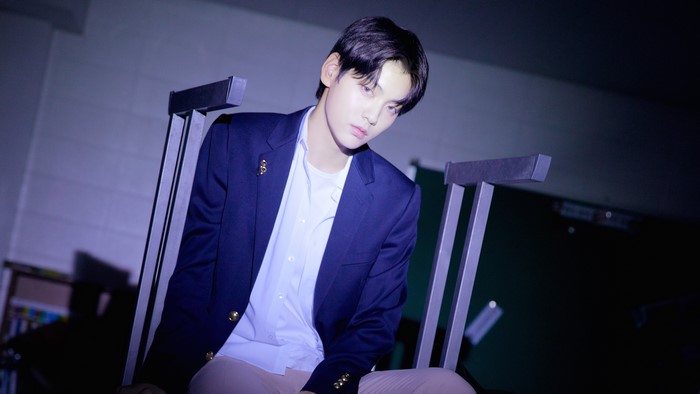 Man in a suit sitting on a chair