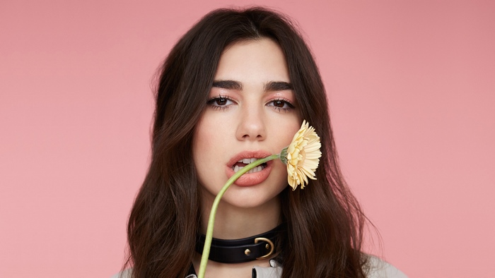 Dua Lipa with a flower