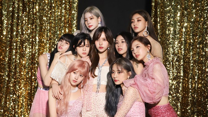 TWICE group photo with gold sequin background