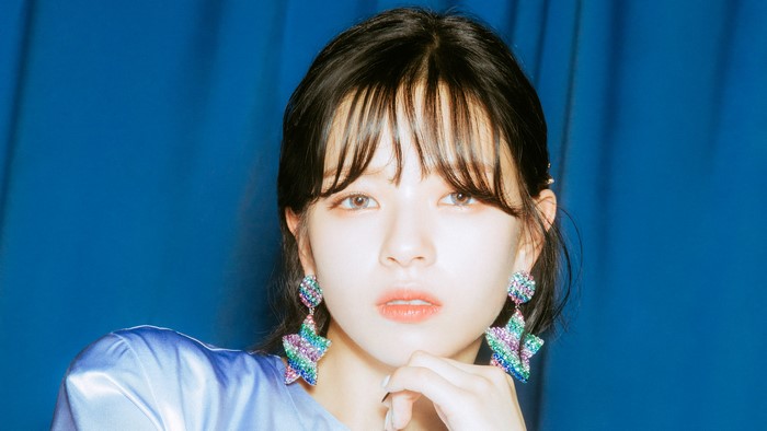Woman with star earrings and blue top