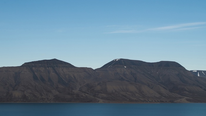 Mountains and ocean under a clear sky
