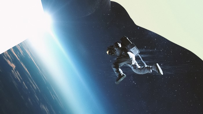 Astronaut floating in space near Earth