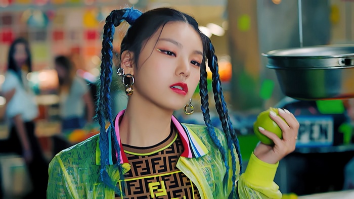 Yeji from ITZY with blue pigtails holding an apple