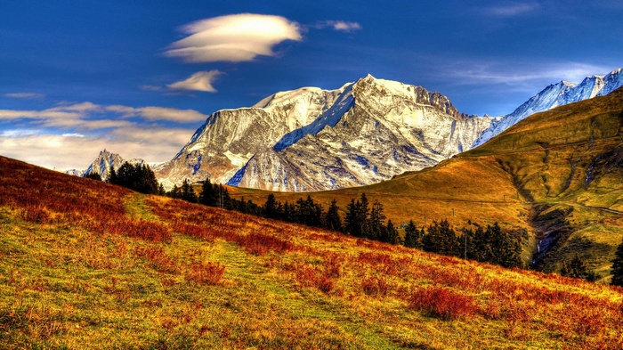 Snow-capped mountains and autumn hillside