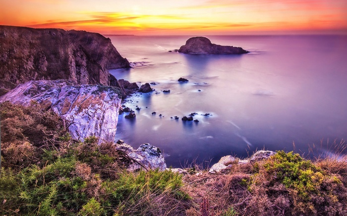 Sunset over rocky coastline and ocean