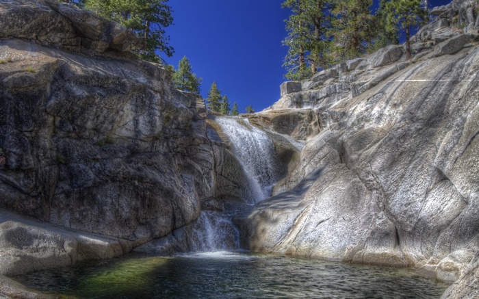 Waterfall cascading over rocks into a pool