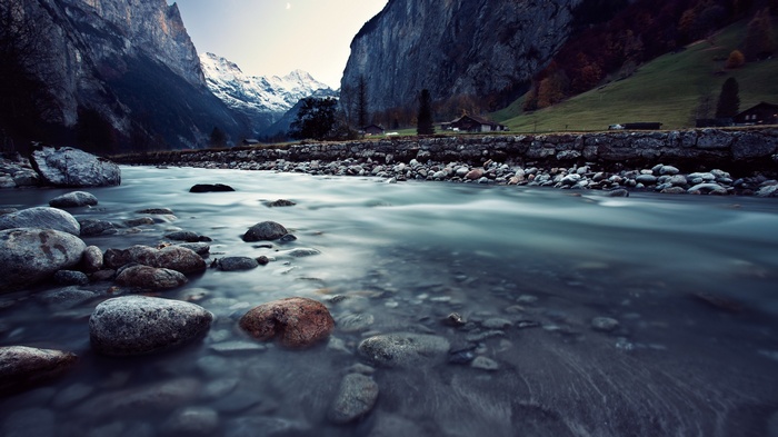 River flowing through a mountain valley with houses