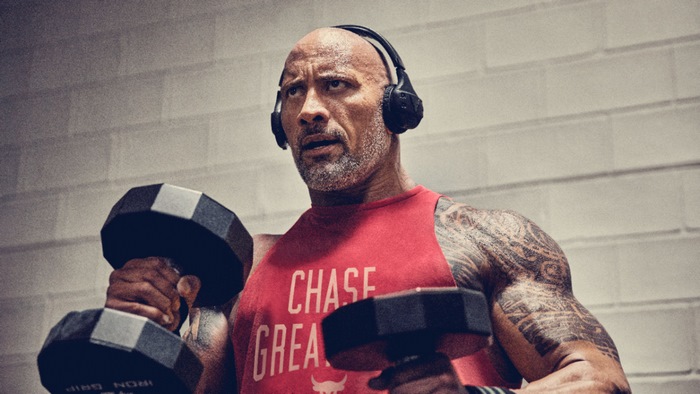Dwayne Johnson working out with dumbbells