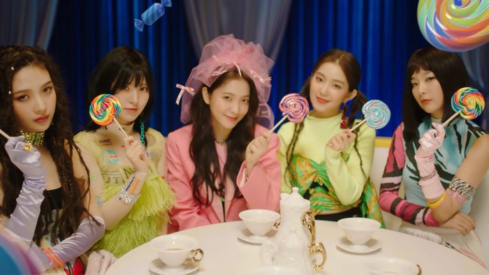 Red Velvet members Joy, Wendy, Yeri, Irene, and Seulgi with lollipops