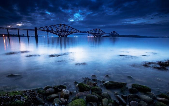 Forth Bridge at dusk over calm water