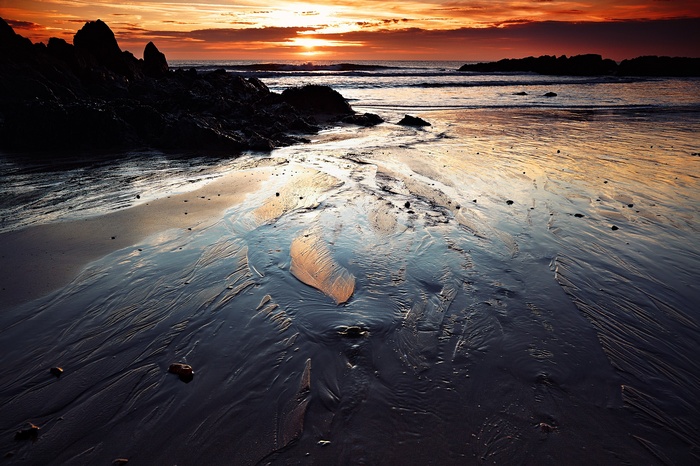 Beach at Sunset with Rocky Outcrops