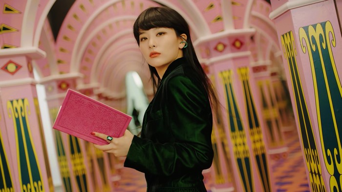Seulgi from Red Velvet holding a pink book