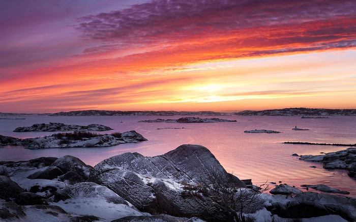 Sunset over a snowy archipelago
