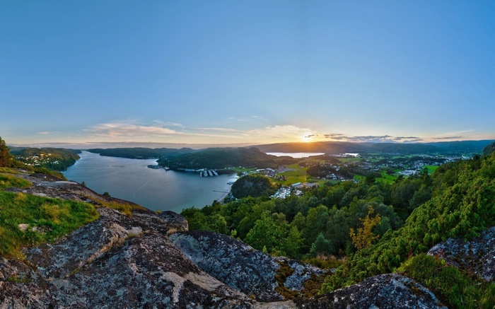 Panoramic view of a fjord and coastline at sunset