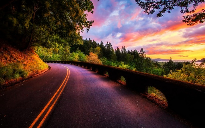 Scenic road at sunset with colorful sky