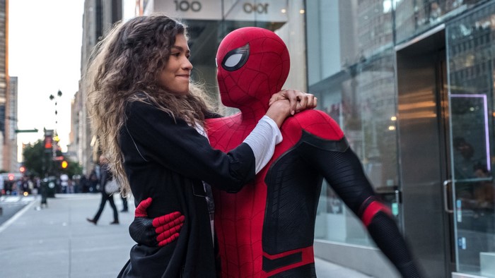 Spider-Man and MJ embrace on a city street