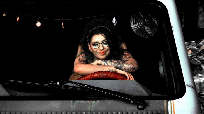 Woman with tattoos and glasses in a vehicle