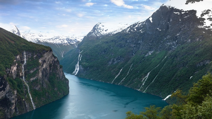 Geirangerfjord with waterfalls and snow-capped mountains