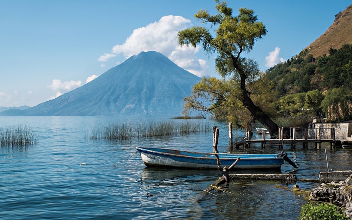 Volcano and Lake Atitlan with a Boat and Dock