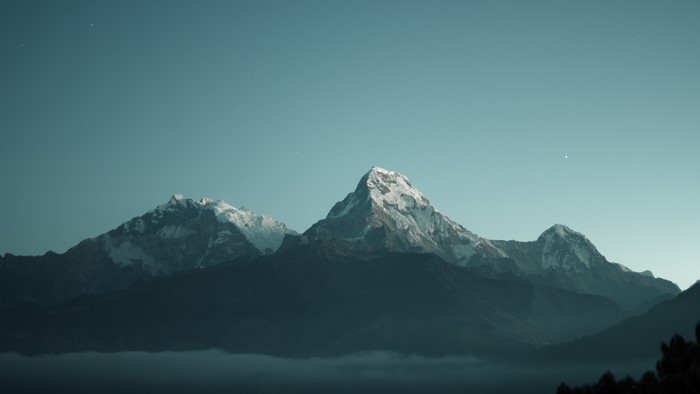Snow-capped mountains under a starry sky