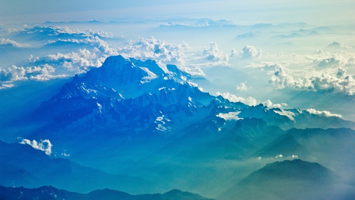 Snow-capped mountains above clouds, 4K