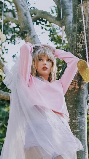 Taylor Swift in pink sweater with veil