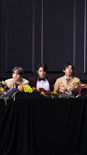 BTS members at a table with fruit