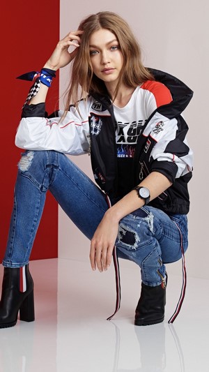 Gigi Hadid in Tommy Hilfiger racing jacket and jeans