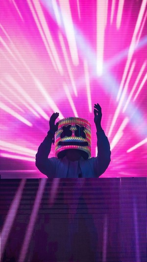 DJ Marshmello performing with neon lights