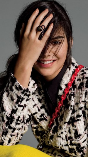 Kendall Jenner smiling with hand over face
