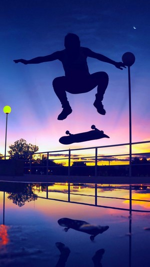 Skater performing a trick at sunset